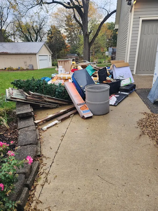 Dumpster being loaded with debris for 10 Yard Dumpster Rental in The Colony